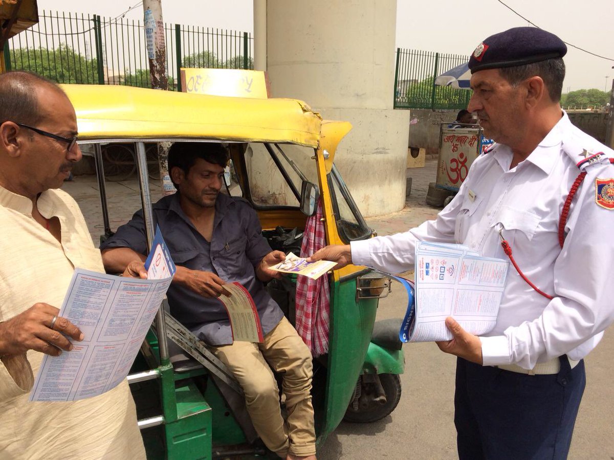 Distribution of road safety literature at Metro Station Ashok Park main.
