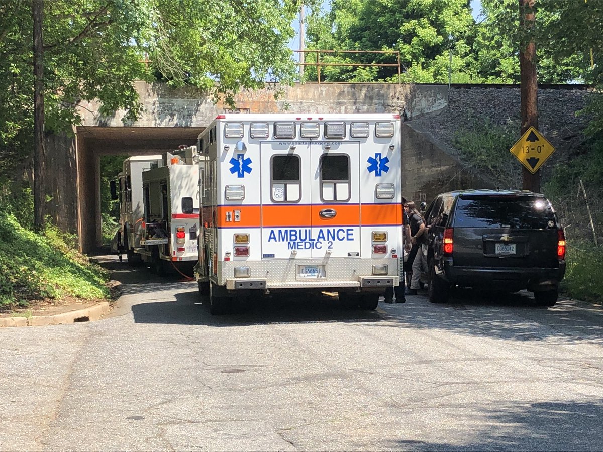 Coroner on scene of crash on Beaumont Ave near Isom Street in Spartanburg. Car appears to have it part of the railroad trestle.