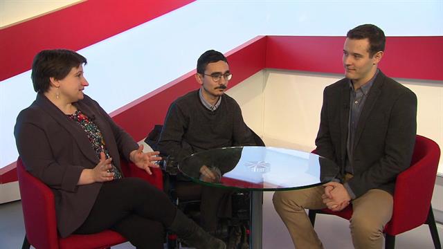 Three people sit at a round table talking in the AMI This Week studio.