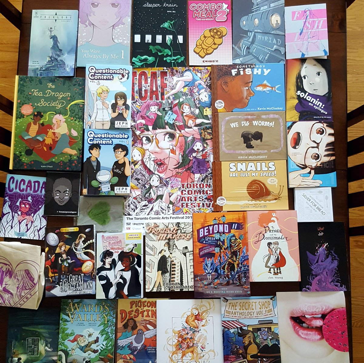 jamieisfeld's tweet photo. As I slowly finish my 12-page travelogue comic, I have to juggle between inks and enjoying some of my incredible #tcaf haul! So many skilled creators! #TCAF2018 https://t.co/jc3ZBlN5rk