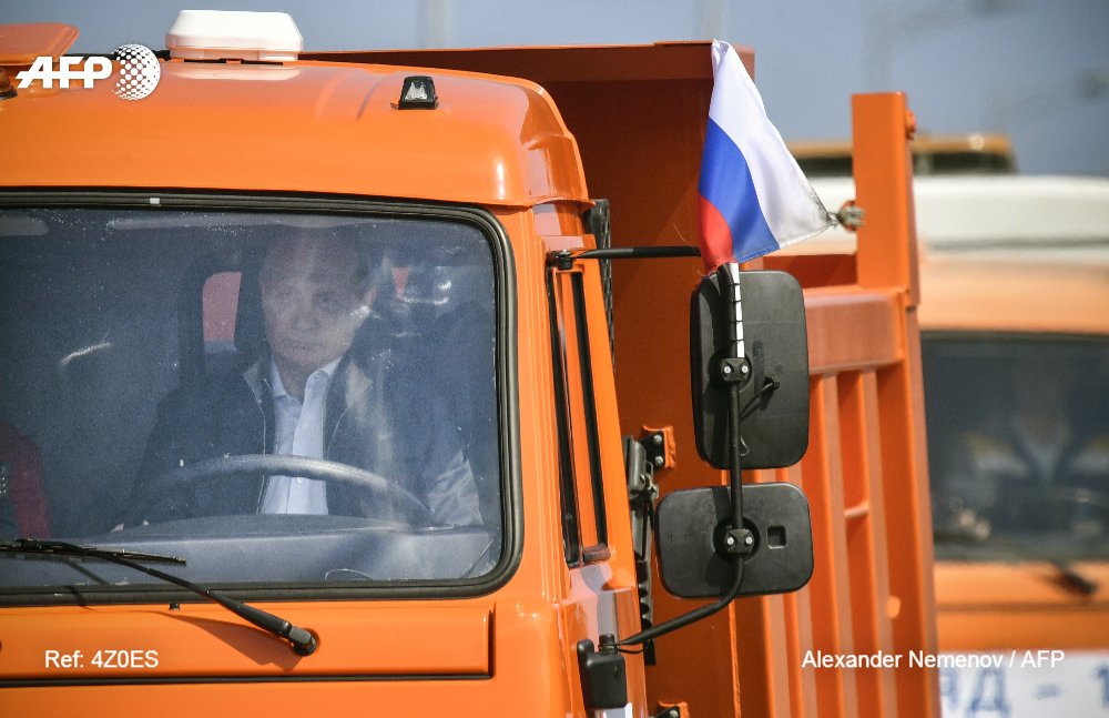 #UPDATE Russian President Vladimir Putin has driven a truck across a new bridge linking mainland Russia to Moscow-annexed Crimea, triggering a fierce reaction from Kiev and the EU u.afp.com/ofWC