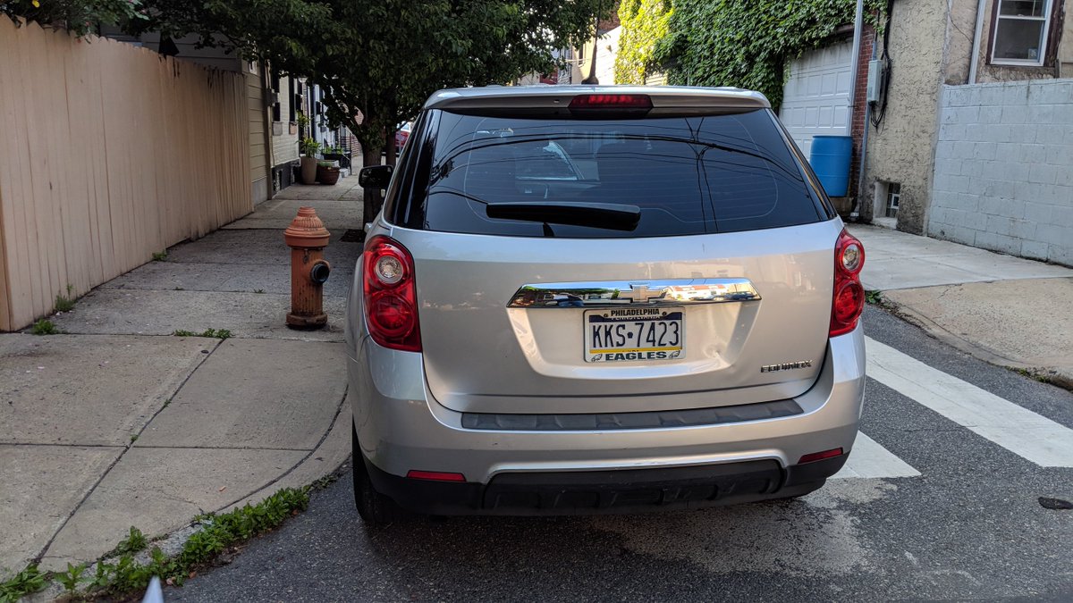 hook_menu's tweet photo. hi @PhilaParking illegally parked car overnight until now at the corner of Tulip St and E. Wilt St (near the rear of St. Laurentius School).  Blocking the crosswalk and a fire hydrant! https://t.co/TYWUno3gk2