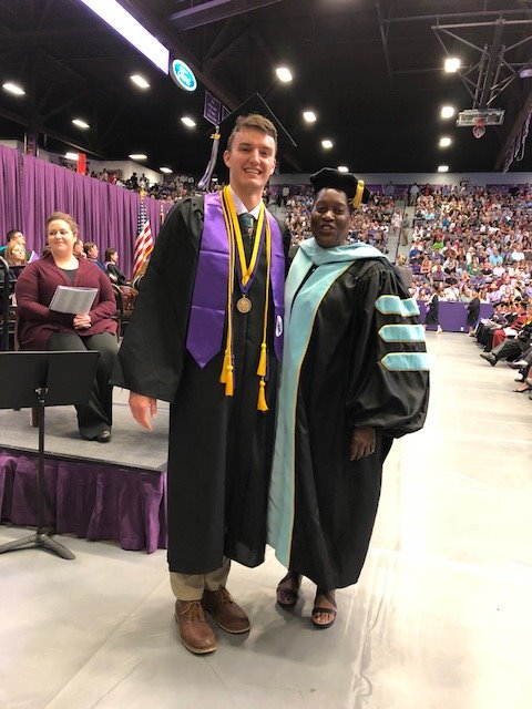 Dr. Deborah Williams congratulates Ben Dickey, graduate of the Interdisciplinary Studies EC-6 program.  Ben founded the SFA Undergraduate Research Club. He has presented at multiple national conferences, including the National Conference on Undergraduate Research.