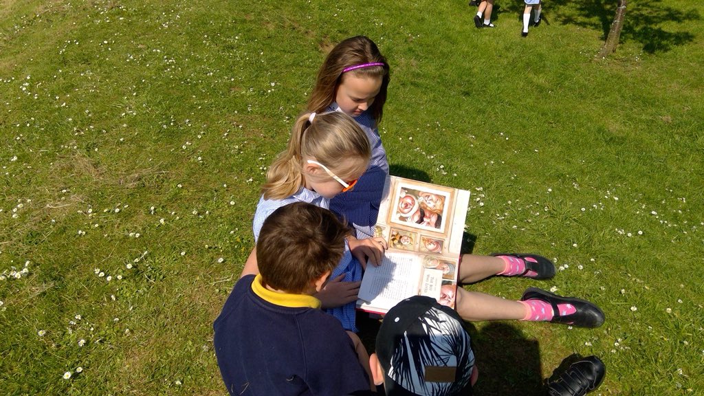 Dustoneldean's tweet photo. A lovely moment during break today. A Yr4 girl decided 2hide her favourite book (in plain sight) 2see who would stumble upon it. 2 x EYFS children discovered it &amp; enjoyed flicking through the pictures. She then offered2 read the story to them&amp; they all enjoyed the story together https://t.co/blYXw1ZR4G