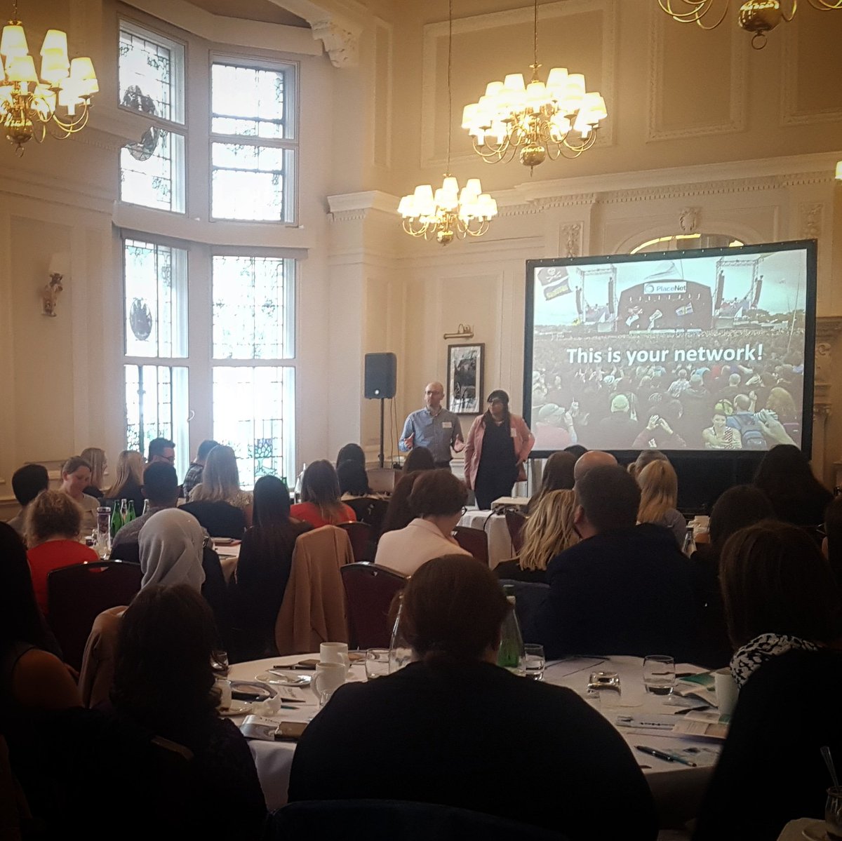 Rachycol's tweet photo. @alexelkins10 @sarahannsheikh kicking off this year's @PlaceNetUK to a full house #PlaceNet18 #thisisyournetwork https://t.co/aOJfljCiDs