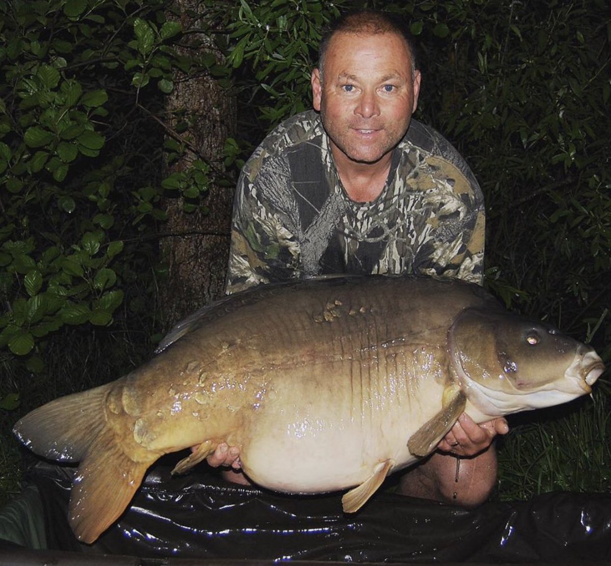 Mick with his new PB “Dots” at 63lb on a pink cell pop up over a large bed of particle &amp; chopped cell #monstercarp