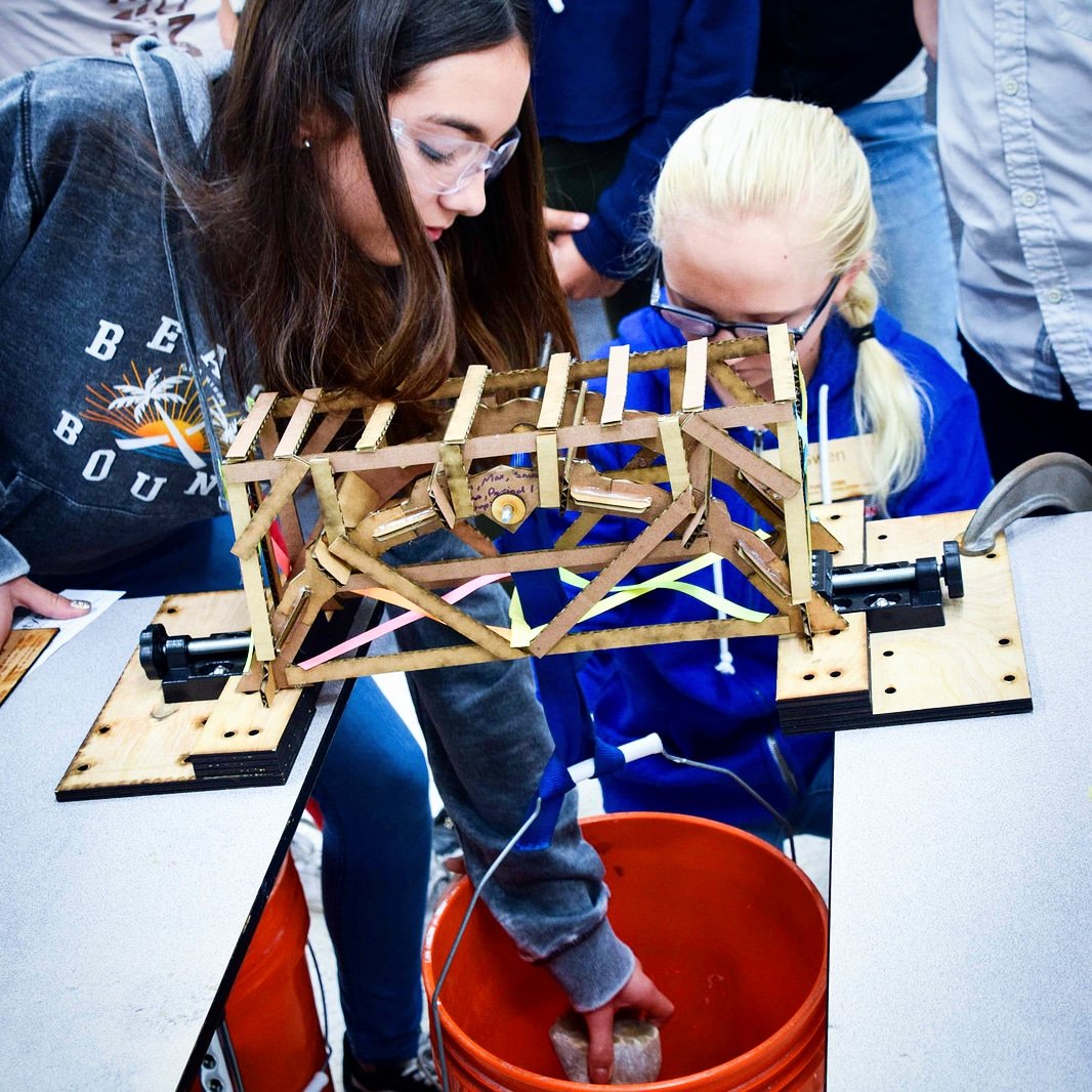 makingSTEM's tweet image. Students test their bridge during the Making STEM engineering challenge. The winner this week could hold 30 pounds #stem #stemchat #edtech #steam
