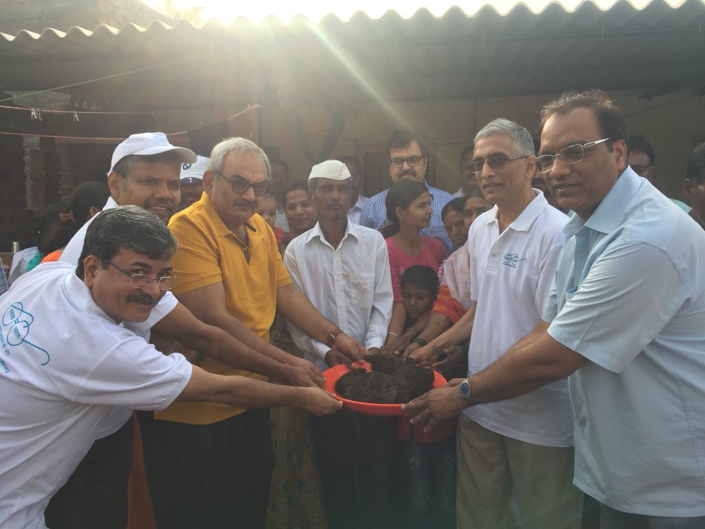 The <a href="/swachhbharat/">Swachh Bharat Mission - Grameen</a> team with the family honored by the presence of Me Rajiv Mehrishi, CAG of India, holding up the human compost from the toilet pit evacuated by the CAG and our team at Pandhrewadi village, Pune this morning.