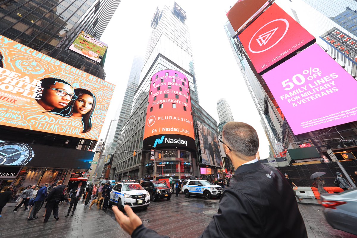 NasdaqExchange's tweet image. The pink and orange shine through on a cloudy day in @TimesSquareNYC 

💓🧡💓 #PluralsightIPO 🧡💓🧡