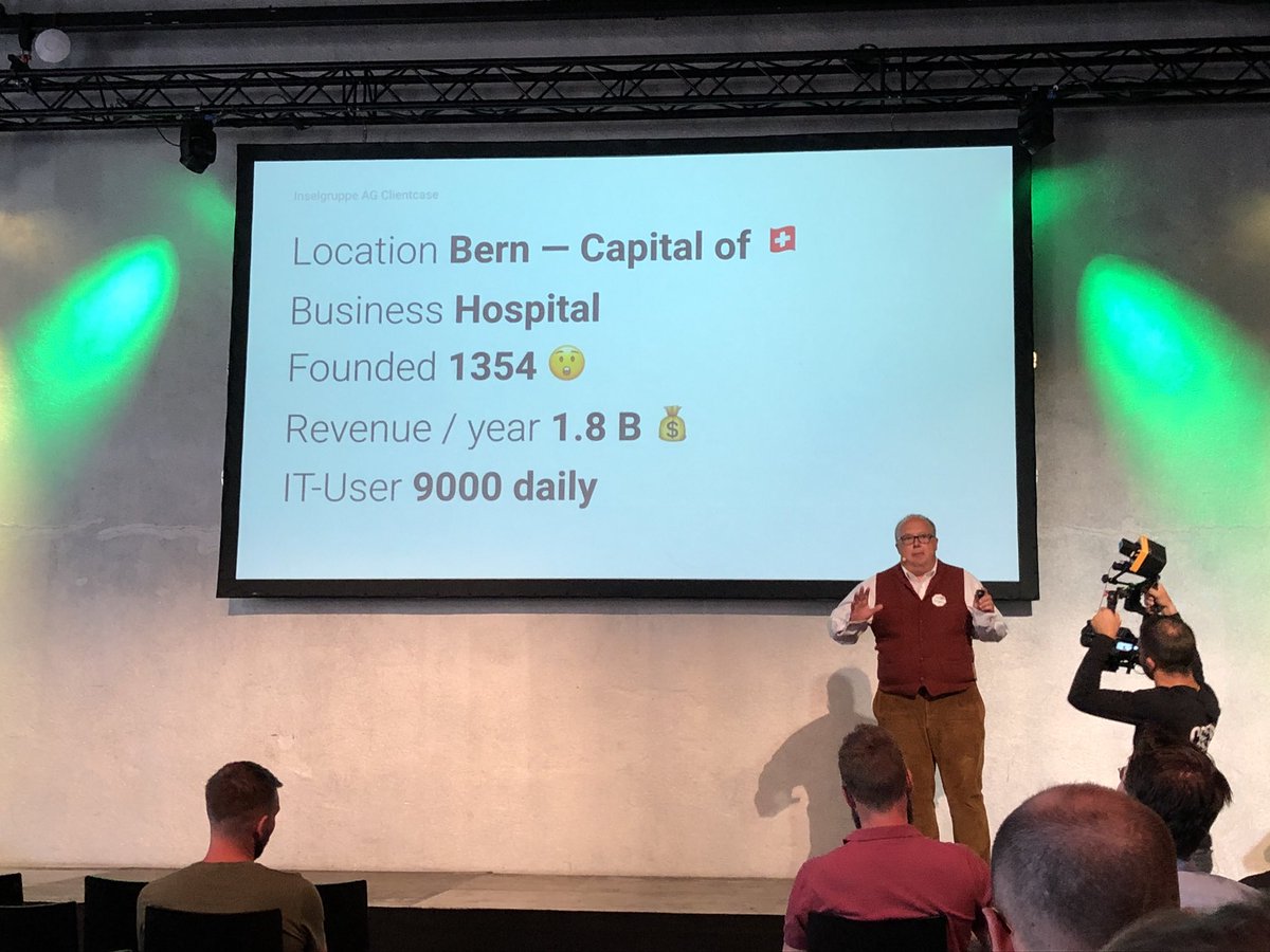 frontkom's tweet photo. Its the second day of @#TargetConf2018, very interesting lightning talks - Jürgen Müller on stage discussing #DigitalTransformation of a Swiss hospital founded in 1354 AD! @targetprocess https://t.co/bETSSqj4D1