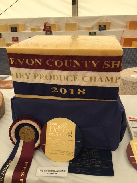 omsco's tweet photo. Delighted that our British Organic Dairy Company mature cheddar cheese has been crowned overall champion dairy product @DevonCountyShow as well as winning both the block mature cheddar cheese (modern) and organic cheese classes @wykefarms #BODC https://t.co/OQSL1Ur7ox
