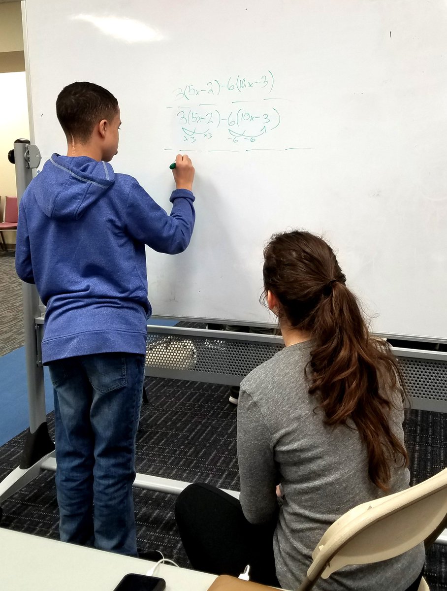 NLA_Pittsburgh's tweet photo. Chanel, a sophomore at CMU, works with Dane on some of his pre-algebra work while Asiya, a current Carlow student, reviews a module of the Keystone with a small group of students before they take the exam this month. https://t.co/ndFtv85TEg
