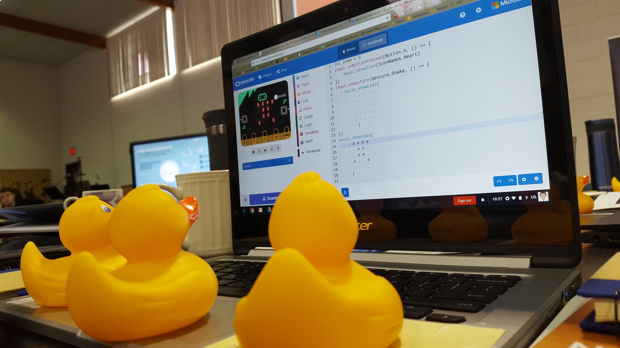 3 rubber ducks in front of a computer