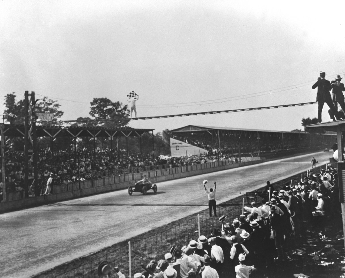 IMS's tweet photo. #500Countdown 9⃣ Days: The checkered flag waves for Tommy Milton as he wins the 9th running of the #Indy500 in 1921. https://t.co/QSfqQVU3Ga