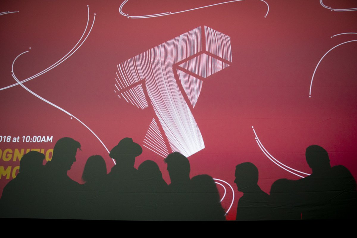 Silhouettes against a red background with the Cornell Tech logo.