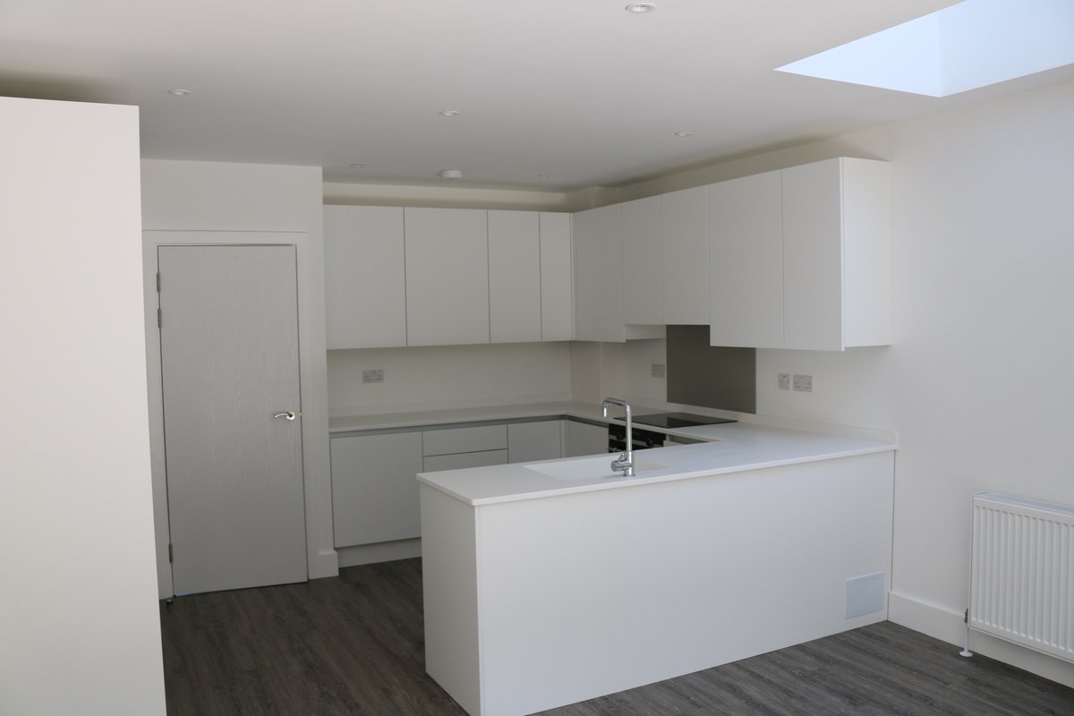 Two satin white kitchens with #corian tops in glacier white and #siemens appliances for a customer in Harold Wood.