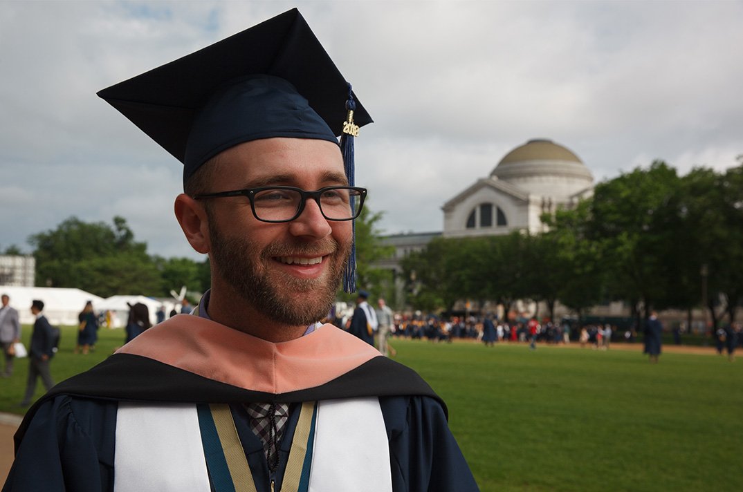 Smiling graduate on the mall