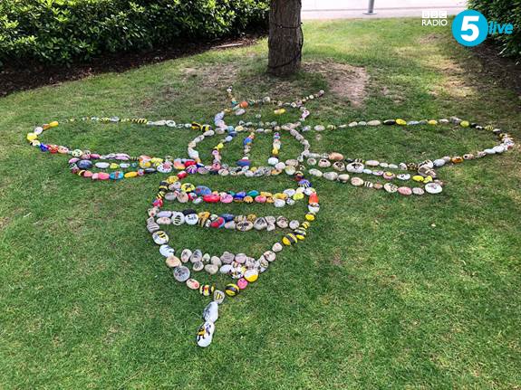 In <a href="/MediaCityUK/">MediaCityUK</a>’s Blue Peter garden, hundreds of painted pebbles in the shape of a worker bee have been laid out by pupils in Manchester, to commemorate the anniversary of the Arena attack.

One pebble says: "This is Manchester, we do things differently".

#ManchesterBuzz