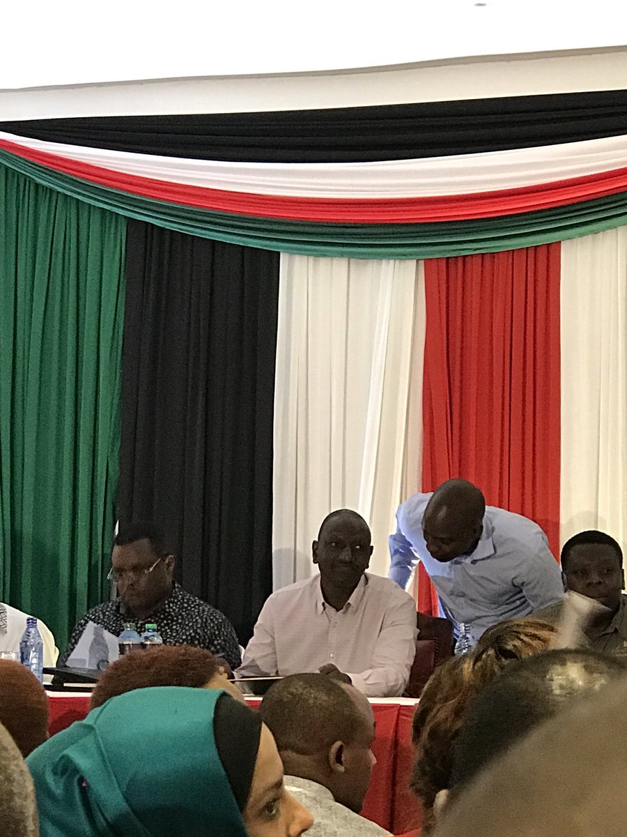 Conomore's tweet photo. The Deputy President @WilliamsRuto is the only one in the room filled with 1,000s of MCAs, Senators and Speakers who is singing the East African Anthem word-for-word.#impressive #Legsum2018 https://t.co/vpBzsZd56A