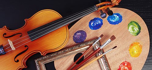 a photograph of an artist's pain pallete and a violin