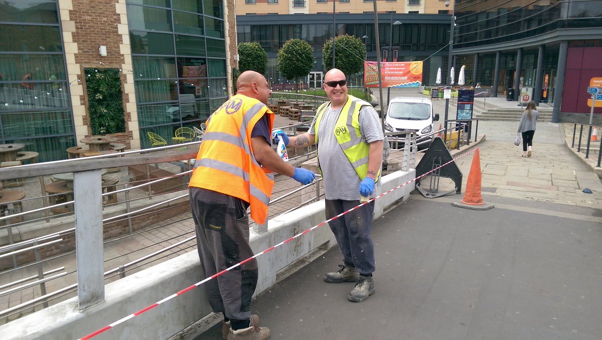 Sprucing up #Leeds - men with rubber gloves, Flash n shades scrub the centenary bridge over the Aire.