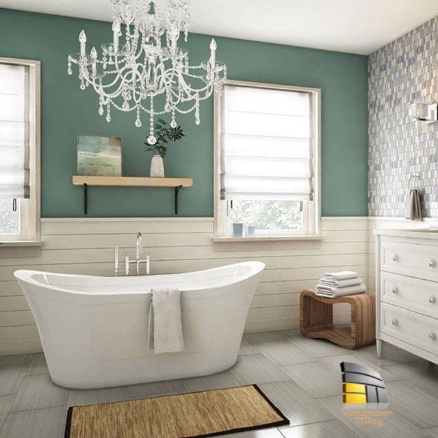 Deep freestanding soaker tub with grey ceramic tiles - Contact ya today to add life to your bathroom! ✅