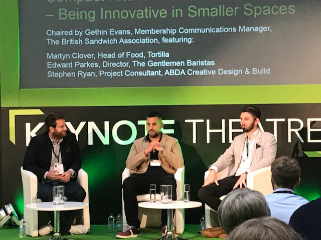 designabda's tweet photo. ABDA's @SryanKE currently onstage in the Keynote Theatre at @comkitchenshow along with @EdwardParkes and @tortillauk's Martyn Clover 👏 🍴☕
#CommercialKitchenShow #compactkitchens #catering #hospitality https://t.co/rt7IRVG65J