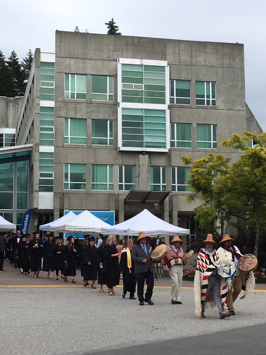 CapilanoU's tweet photo. Indigenous singing and drumming leads the opening procession for CapU's Convocation. Congrats to all of our graduates! Watch the ceremonies, live, here: https://t.co/MXUTnY5Zh7 #CapUPride #CapUGrads #CapUGrad2018 #CapUGrad #NorthVan https://t.co/2Uy0savWTN