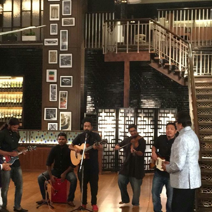 SrBachchanclub's tweet photo. T 127 - Pics Update.. . there is music .. a band plays introduction.. they are the Kabir Cafe .. a bunch of enthusiastic musicians dressed in black and only play Kabir Dohas .. credible and very unique . #StarryNight2 @SrBachchan https://t.co/UAKFT4ftlr