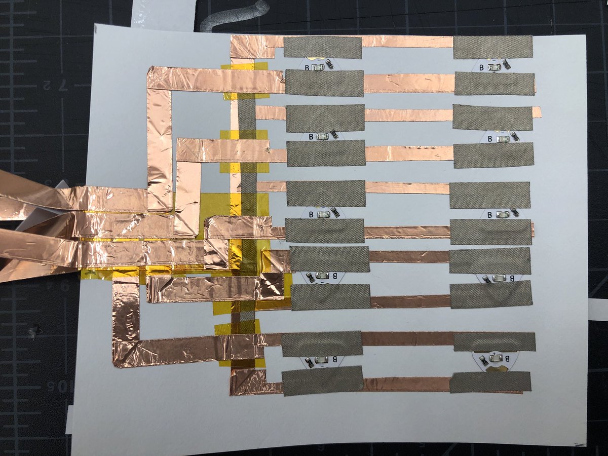 joshburker's tweet photo. Double layer #paperCircuit. Conductive copper tape, conductive fabric tape, insulating laptop tape, @chibitronics LED stickers. Circuit will connect to Chibi Chip. #maker #programming #art https://t.co/JgkHX4PbYq