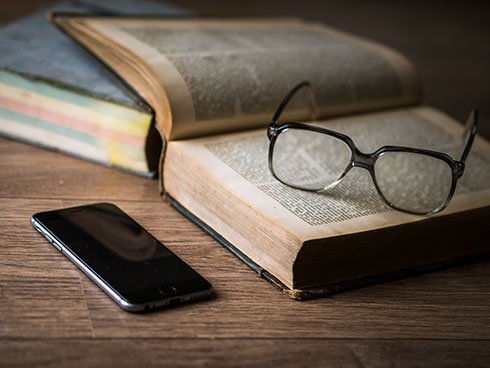 book with smartphone and glasses.