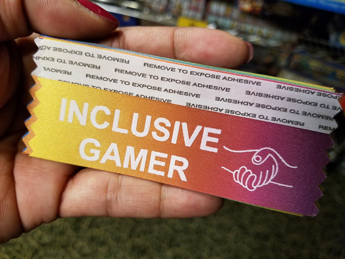 MeepleLady's tweet photo. I have ribbons to pass out, courtesy of @discountcompost. #inclusivegamer #BGGSpring2018 https://t.co/fpTqcN6Efy