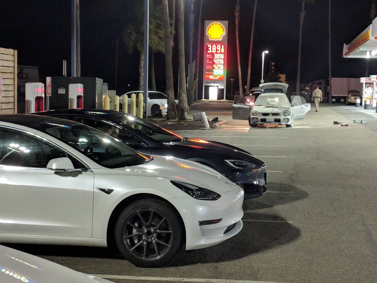 jiteshs_'s tweet photo. Teslas chillin on the backdrop of a gas car that spontaneously caught on fire. #FutureIsHere symbolic isn't it @elonmusk ? https://t.co/Wt3jOEyHuV
