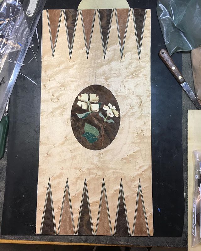 pconstantian's tweet photo. Sneak preview. This is actually the back side of the board that will eventually be glued down. I’ve removed the blue tape from this side. All the pieces are being held together by the white, hide tape on what will be the front. #marquetry #backgammon #wo… https://t.co/8hPAOEcnfV https://t.co/ARKgRWA93F