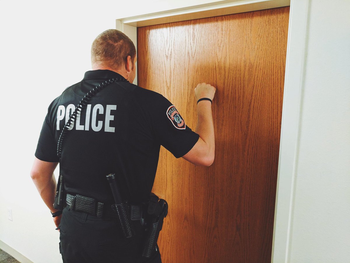 Police officer knocking on a door