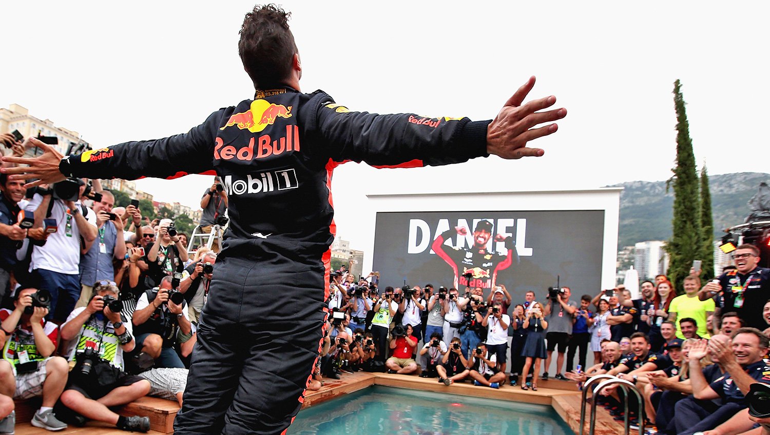 Daniel jumps in the pool following victory at the Monaco Grand Prix.