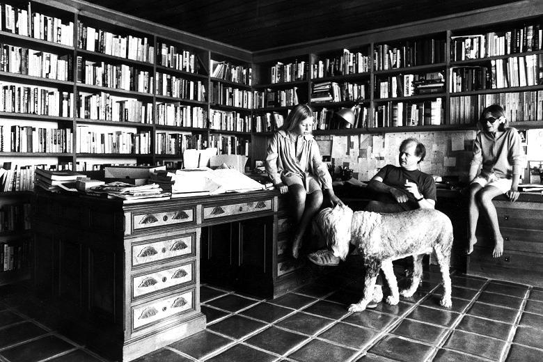Writers Joan Didion and John Dunne at their Malibu home surrounded by books, 1976.