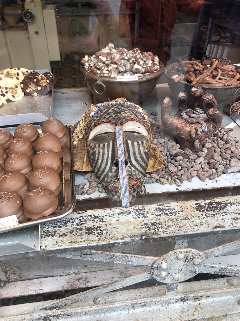 Carlee_Forbes's tweet photo. African art in weird places... this time in the window of a chocolate shop in Bruges. Can we also talk about that hand? https://t.co/SEkIWWDkeS