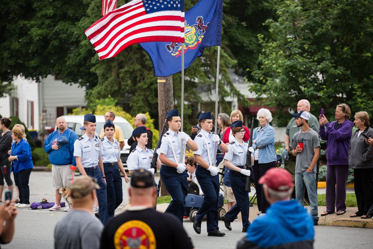 Image of parade participants holding the US and PA flags.