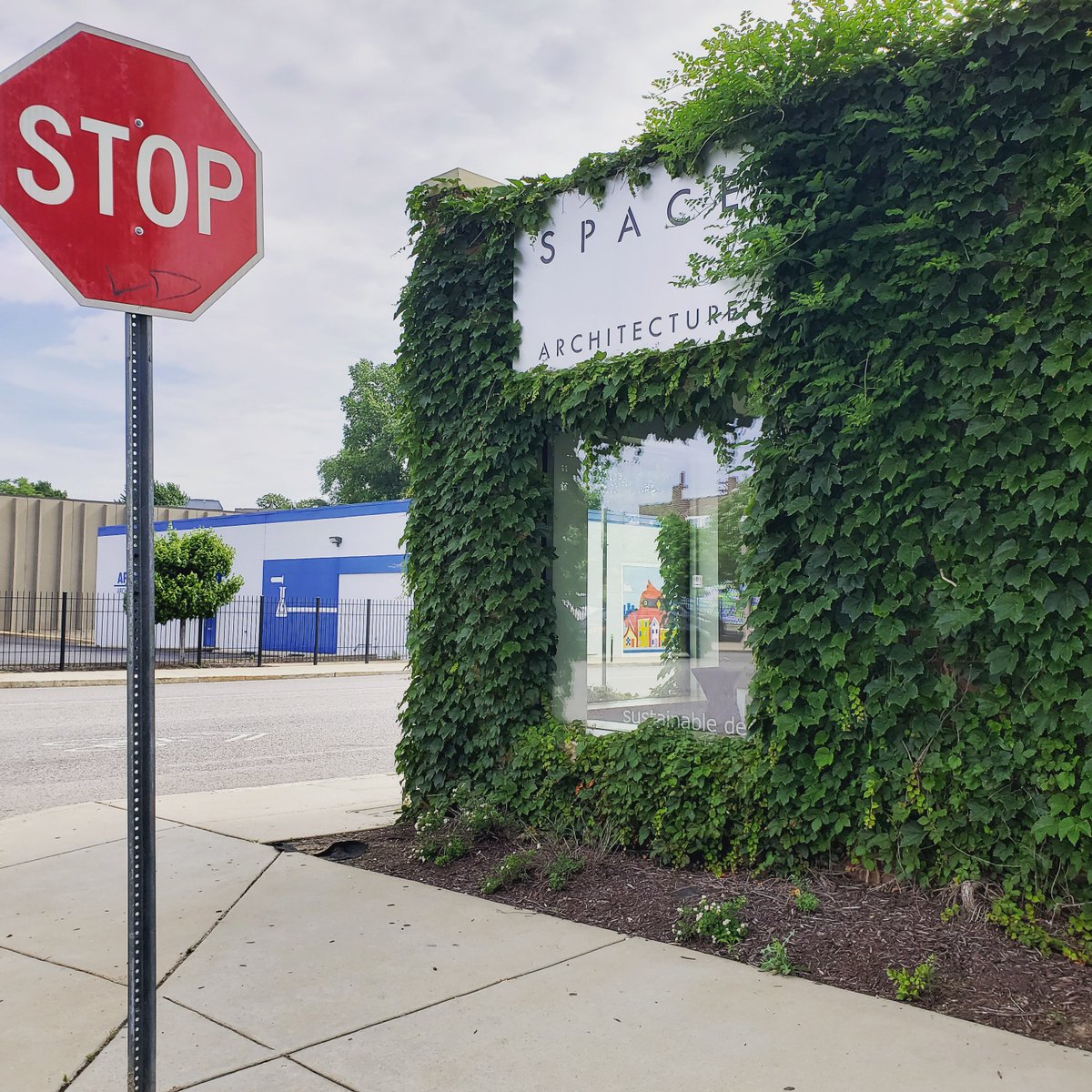SPACEarchitects's tweet photo. Our greenery is coming back with a vengeance. Take a hint from the sign, nature! 

. 
.
#architecture #design #greenery #foliage #nature #exteriors #viewsfromspace https://t.co/O6T7TBa9JS