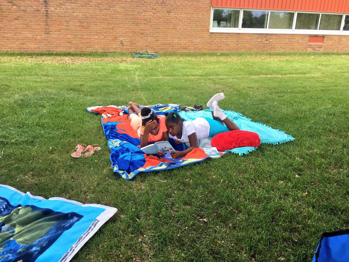 WW_3rd's tweet image. Relaxing and reading together out in the grass. 🌱☀️📚 #lastdaysof3rdgrade #outsideday