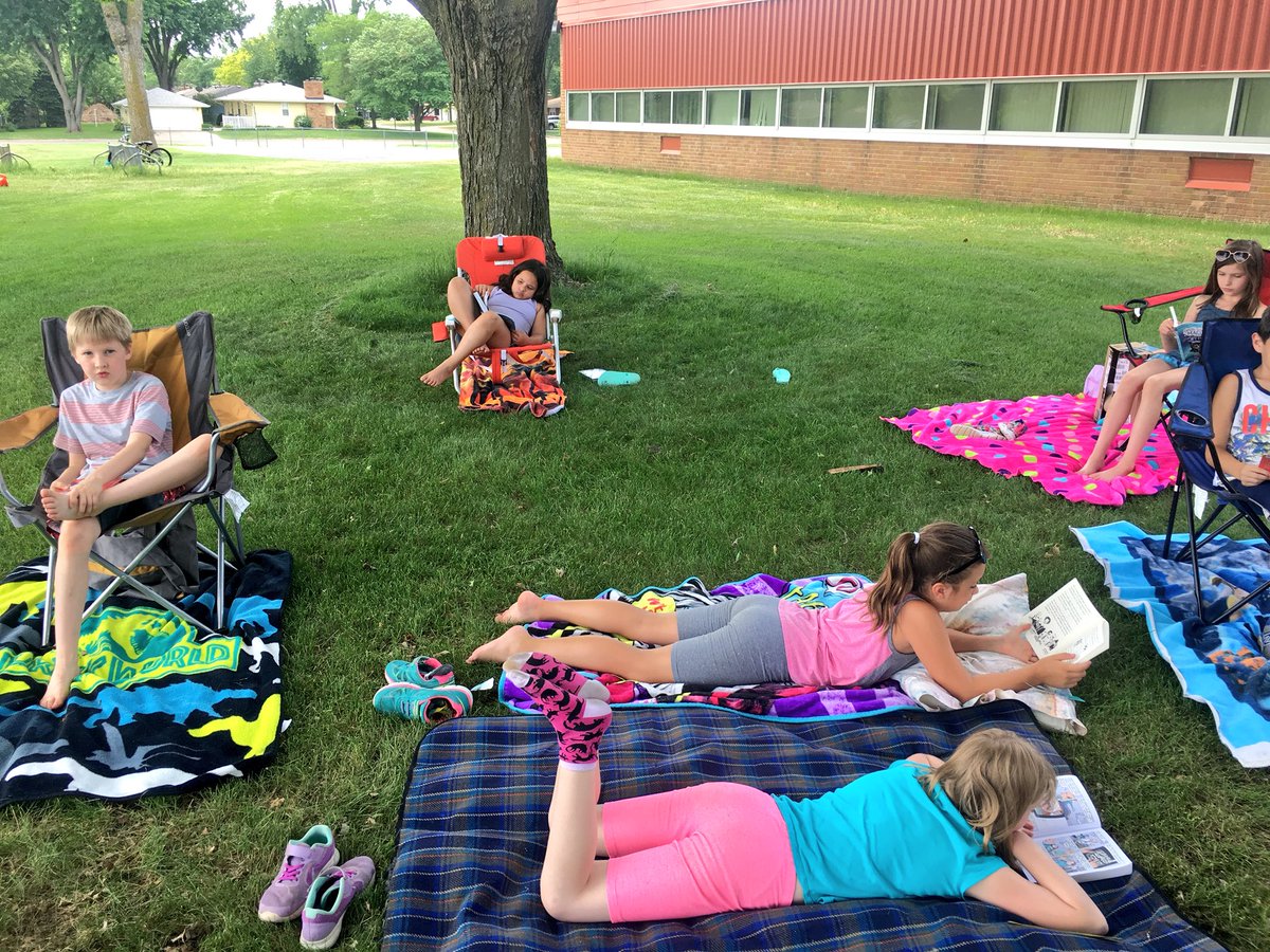 WW_3rd's tweet image. Relaxing and reading together out in the grass. 🌱☀️📚 #lastdaysof3rdgrade #outsideday
