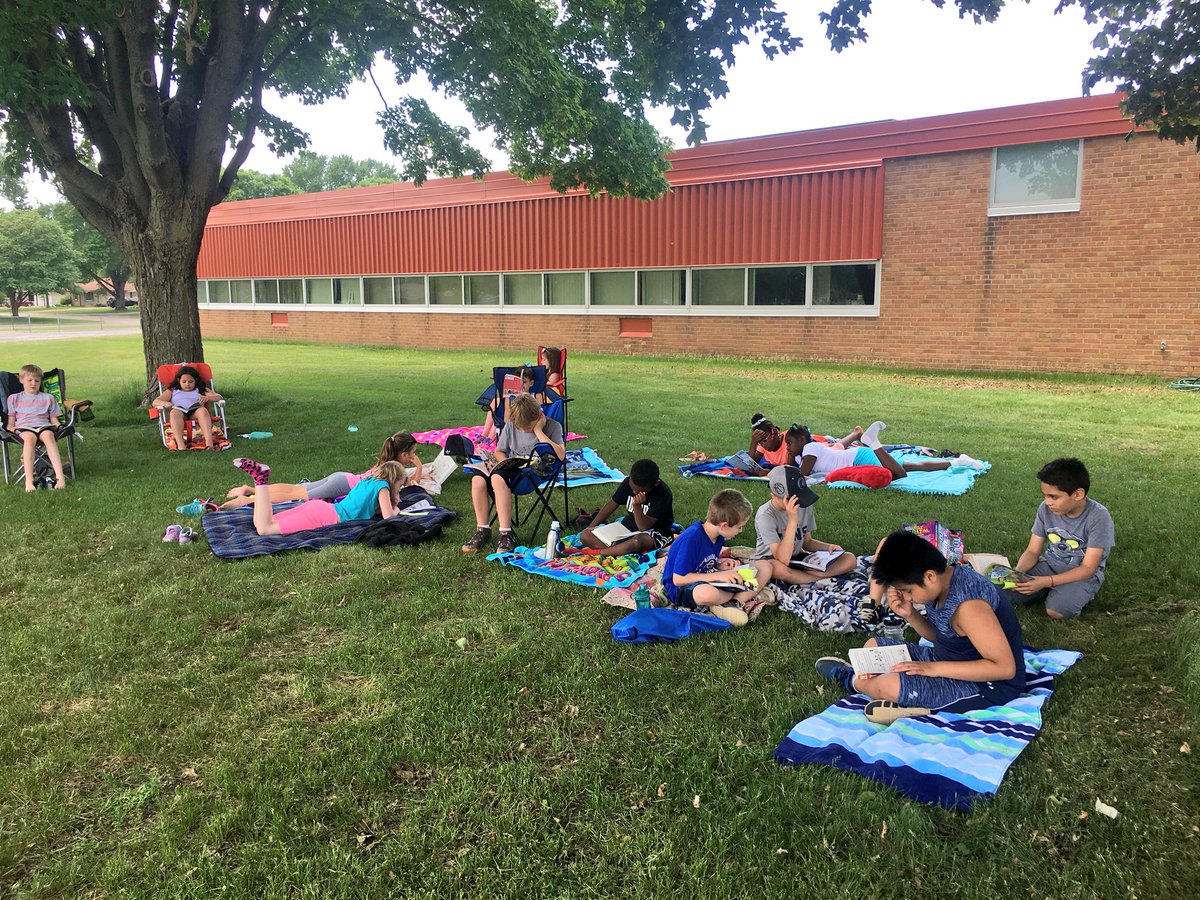 WW_3rd's tweet image. Relaxing and reading together out in the grass. 🌱☀️📚 #lastdaysof3rdgrade #outsideday