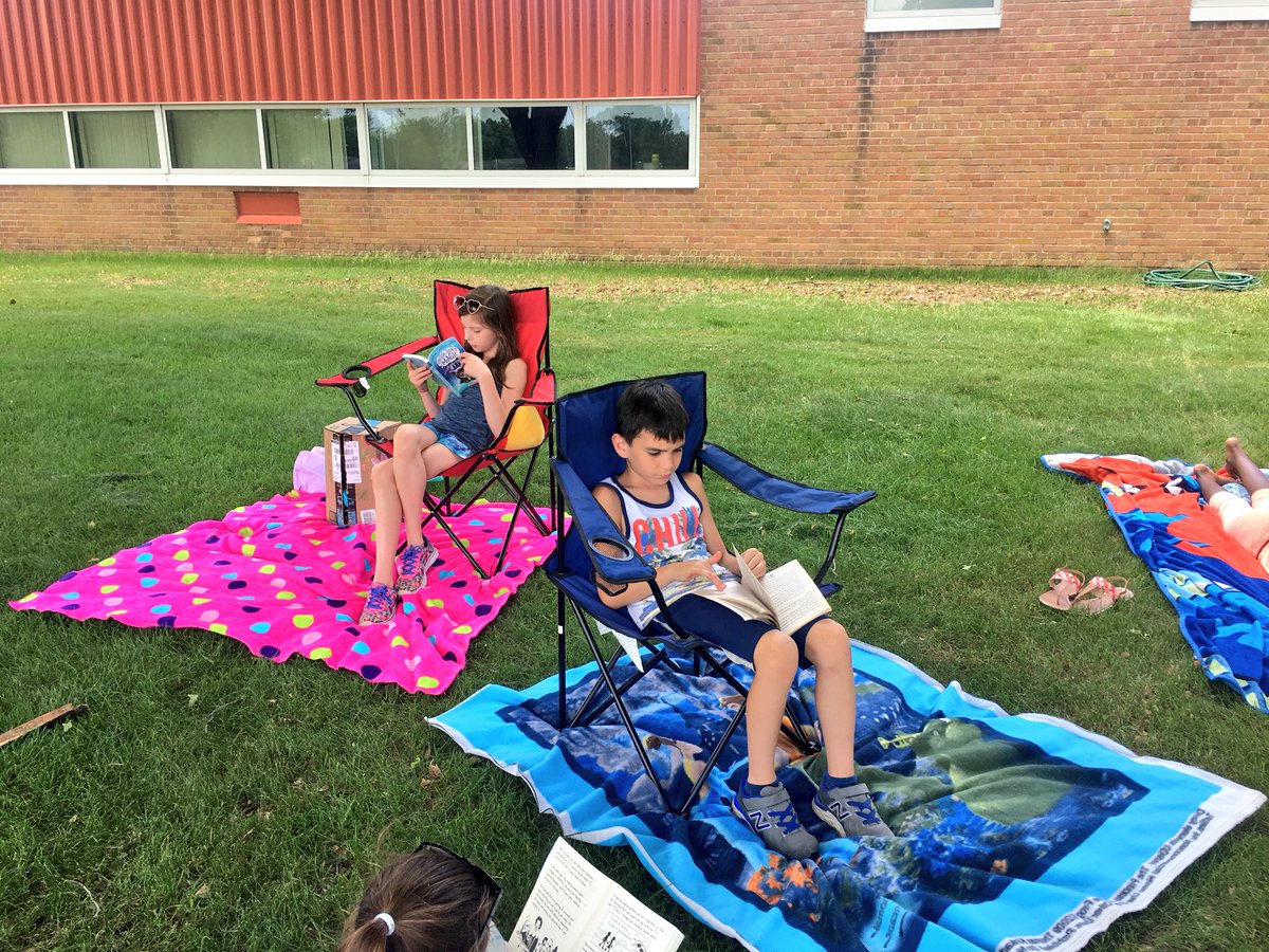 WW_3rd's tweet image. Relaxing and reading together out in the grass. 🌱☀️📚 #lastdaysof3rdgrade #outsideday