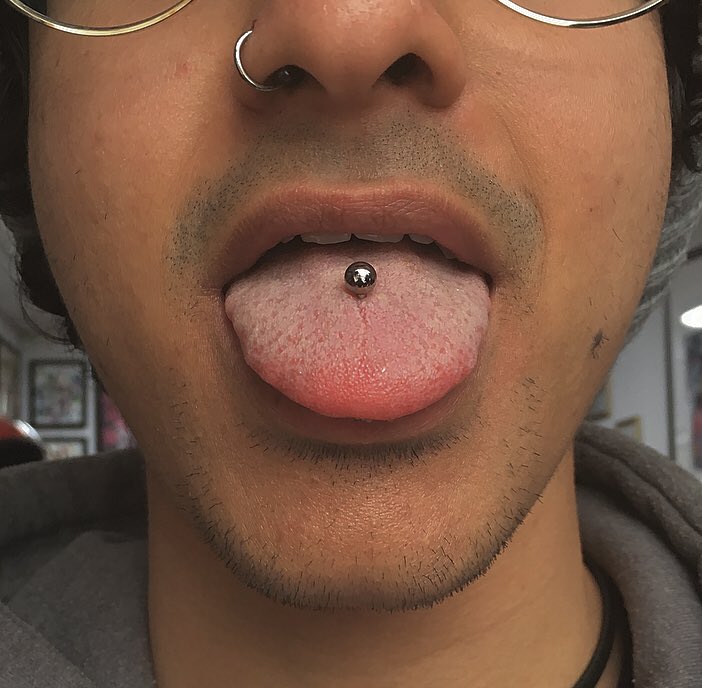 Piercing male tongue