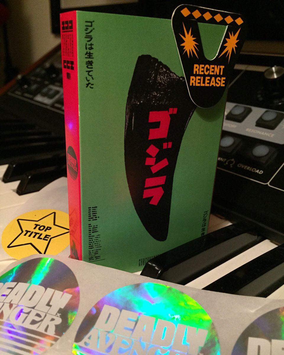 BurningAWitch's tweet photo. We only release Top Titles on cassette! @AvengerDeadly I AM GODZILLA, YOU ARE JAPAN. Vinyl, Cassette and combo bundle deal this Friday 1st June 10am BST. Includes download card and artwork by @LukeInsect #iagyaj #cassette #vinyl #deadlyavenger #toptitle https://t.co/BNznEB7j8t