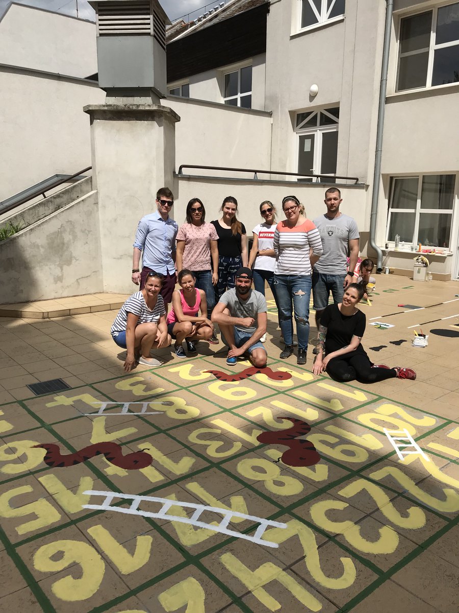StarbucksEMEA's tweet photo. A team from Starbucks stores in #Budapest have been painting new hopscotch and twister playground games to help children at Jรณzsefvรกrosi Elementary School to learn letters and numbers #globalmonthofservice https://t.co/C1foLJ0ny2