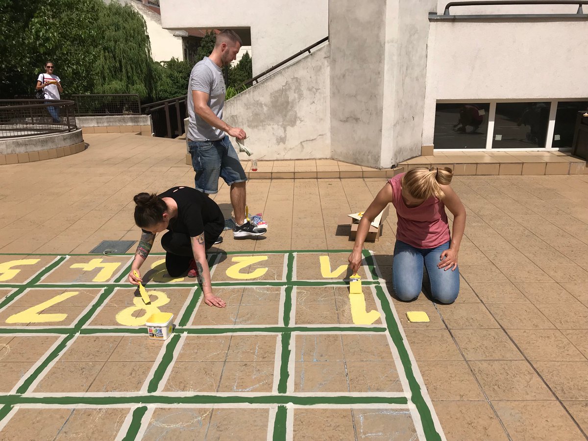 StarbucksEMEA's tweet photo. A team from Starbucks stores in #Budapest have been painting new hopscotch and twister playground games to help children at Jรณzsefvรกrosi Elementary School to learn letters and numbers #globalmonthofservice https://t.co/C1foLJ0ny2
