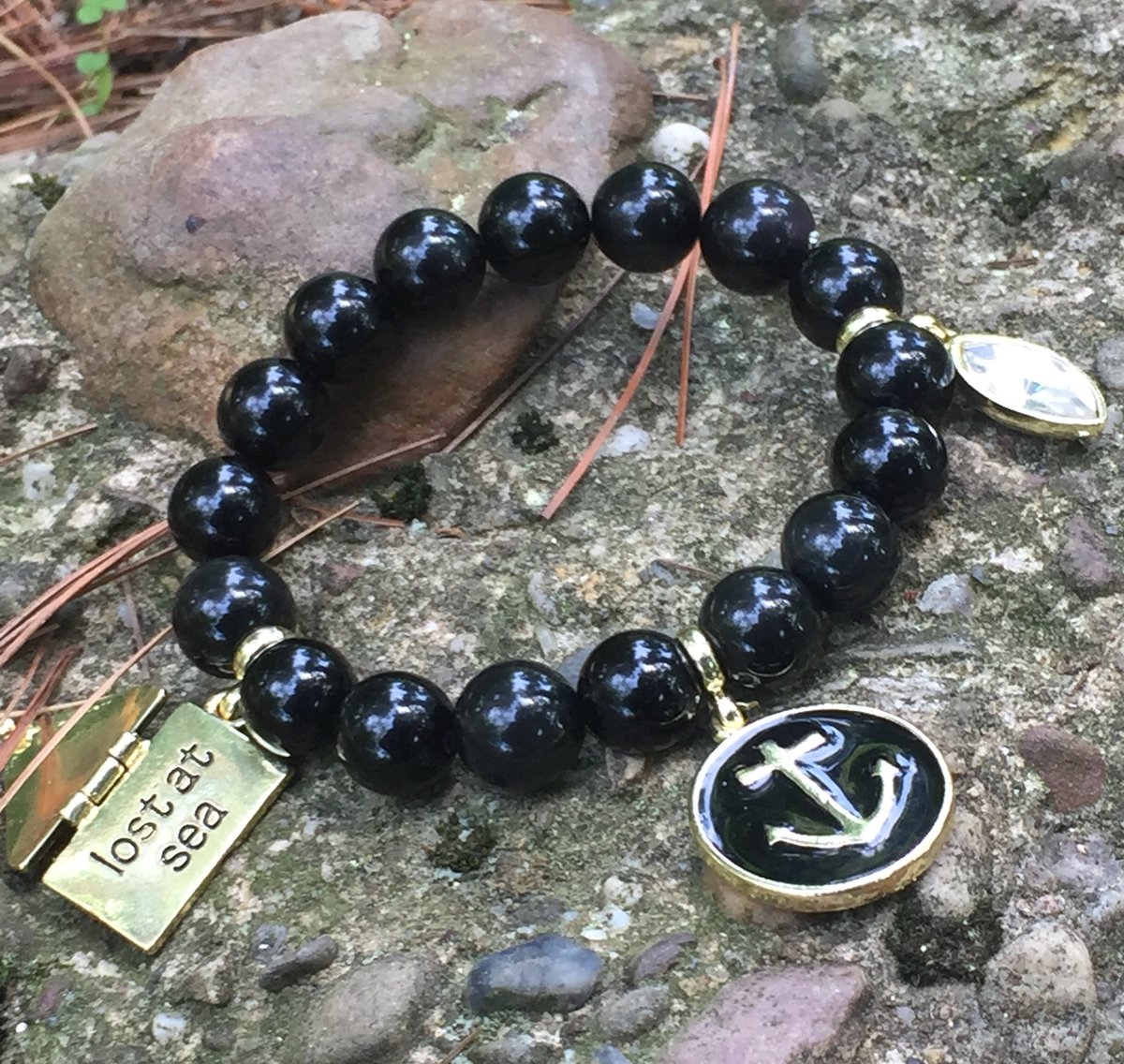 💛 #Obsidian “Lost at Sea” beauty #vision to reality...come check her out @oursbaidesign 🖤#obsidianbracelet #obsidianjewelry #lostatsea #sailingjewelry #giftsforhim #giftsforher #yachtlife #yachty #yachtylife #supportsmallbusiness #supportblackbusiness #handmadecrafts #handmade