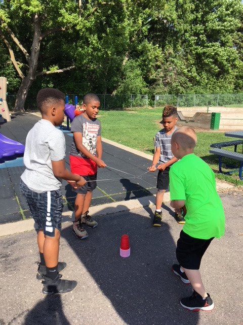 LHTanglenSchool's tweet photo. Mrs. O'Neil's second graders met with their buddies from Ms. Deehr/Hovanetz fifth grade class for a cup building challenge. Without using hands, and only a rubber band and strings, they needed to work together to build a pyramid of cups. Awesome team building! #TanglenPride https://t.co/wuUkTd9l6C